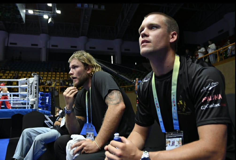 Oceania coaches supporting athletes beside the ring